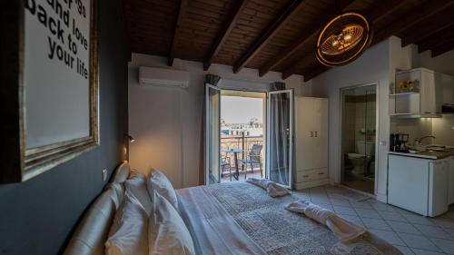 a bedroom with a bed and a view of a kitchen at Studios Vaso - Center in Parga