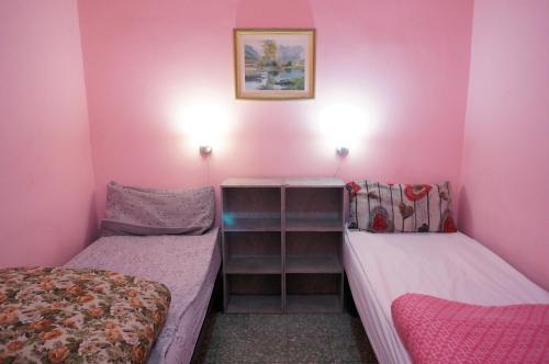 מיטה או מיטות בחדר ב-Affitti brevi "Max FORTUNA"