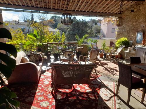 a patio with a table and chairs and a view at LA TERRASSE VIGNERONNE in Fitou