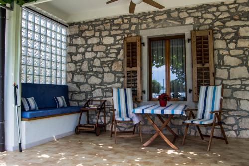 a porch with chairs and a table and a window at Apartment Derossi in Umag