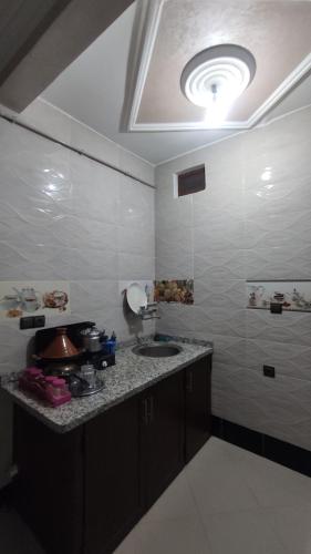 a kitchen with a sink and a counter top at IAZAL Hotel Ouarzazate in Ouarzazate
