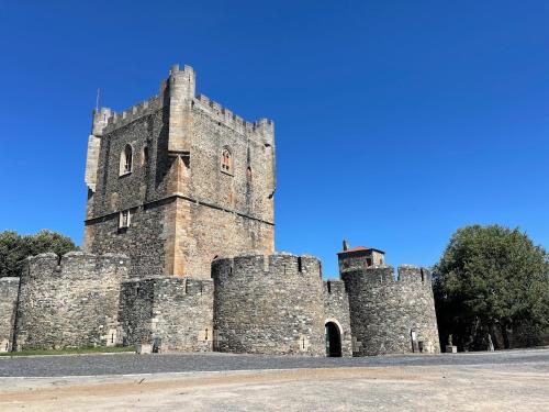 a castle with three towers with a blue sky in the background at Casa de Campo - Vila Boa in Vila Boa