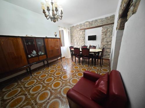 a living room with a table and chairs and a couch at B&b Diamante and home restaurant in Trentinara