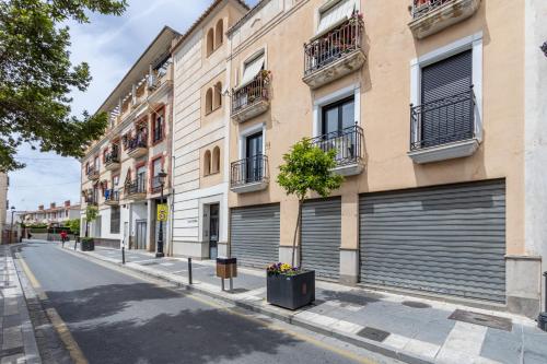 a street with two garage doors on a building at Dreaming Ogíjares in Ogíjares