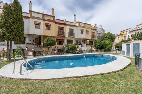 a swimming pool in front of a building at Dreaming Ogíjares in Ogíjares