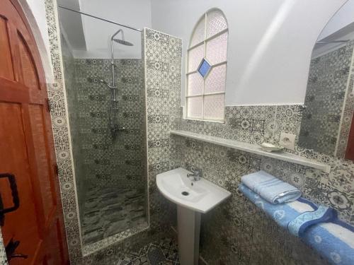 a bathroom with a sink and a shower at Dar Fatima in Chefchaouene