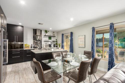 a kitchen and dining room with a glass table and chairs at Hot Tub, Heated Pool, Mini Golf, BBQ, 500 Mbps, 50in TV, Old Town in Scottsdale