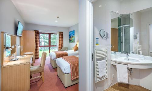 a hotel room with a bed and a bathroom at High Range Lodge Hotel in Aviemore