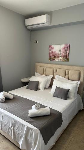 a large bed with two towels on top of it at Anna House Dhermi in Dhërmi