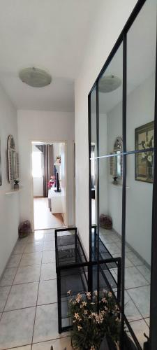 a living room with a staircase and a mirror at Apartments Ita - Postira in Postira