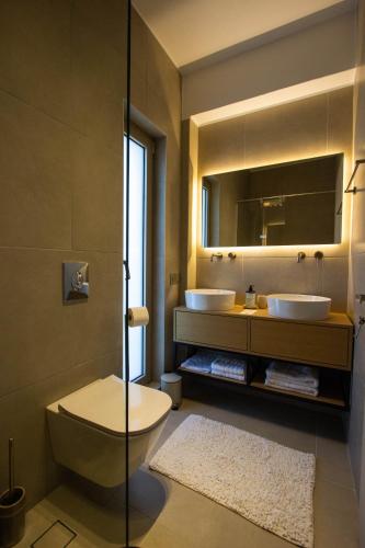 a bathroom with two sinks and a mirror at Villa Ninemia in Agia Galini