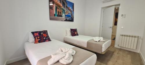 a room with two beds with towels on them at Malasaña II in Madrid