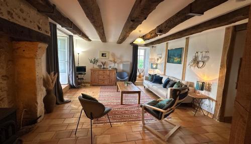 a living room with a couch and chairs at Gites Boutique in Villamblard