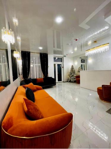 a living room with a large orange bed in the middle at Salut in Bukovel