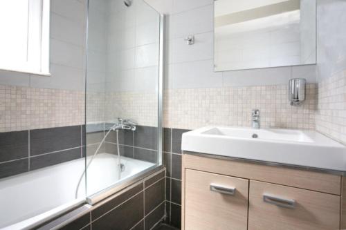 a bathroom with a sink and a bath tub and a sink at Elea in Kato Daratso