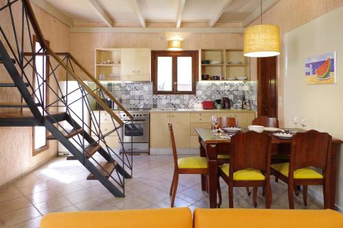 a kitchen and dining room with a table and chairs at Elea in Kato Daratso
