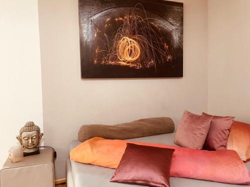 a living room with a couch and a picture on the wall at Gemütliche Wohnung idyllische Lage Nähe Frankfurt in Alzenau in Unterfranken