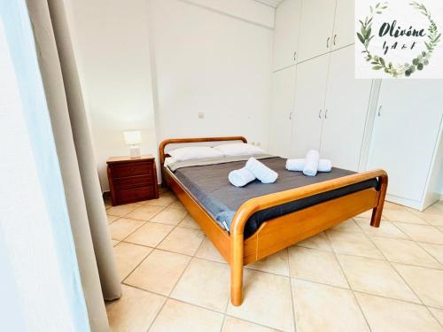 a bedroom with a bed with two pillows on it at Olivóne apt, by A & F in Igoumenitsa