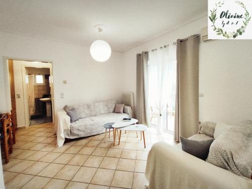 a living room with a couch and a table at Olivóne apt, by A & F in Igoumenitsa