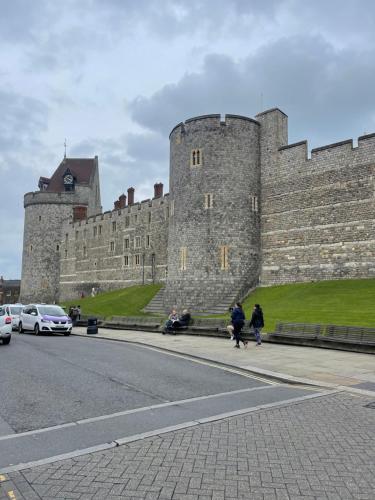a castle with people walking on the sidewalk in front of it at Central Windsor in Windsor