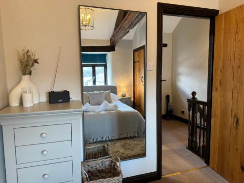 a bedroom with a bed and a large mirror at Three - Yard 12 in Kendal