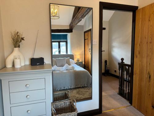 una camera da letto con un letto e un grande specchio di Number Three, Yard 12 Kendal a Kendal