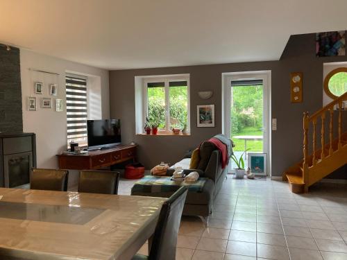 a living room with a couch and a tv at Mignonne in Mauron