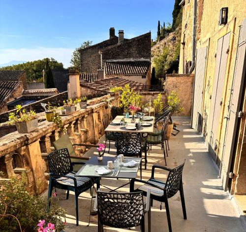 a group of tables and chairs on a patio at La vie de chateau in Grignan