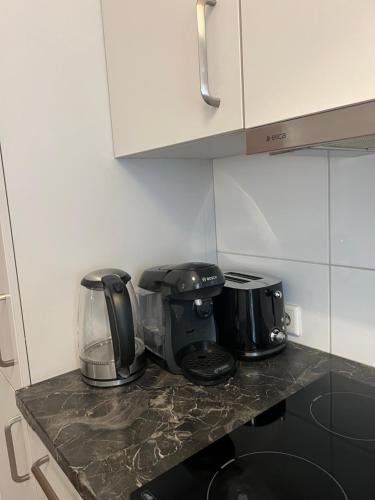 a kitchen counter with two toasters on top of it at TMJ Apartment 1 in Düsseldorf
