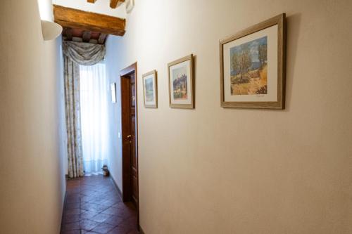 a hallway with paintings on the walls of a house at Antica Casa Dei Rassicurati in Montecarlo