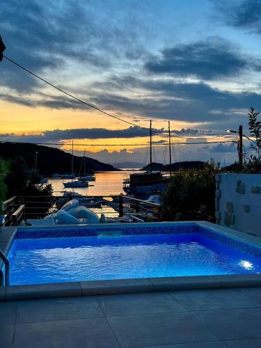 a swimming pool with a view of a marina at Beach Villa Ema in Rab