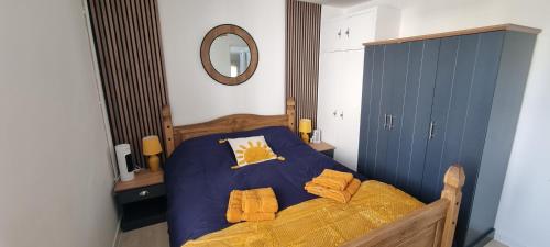 a bedroom with a bed with yellow sheets and a mirror at The Hideaway ll private garden Quiet Central in Southport