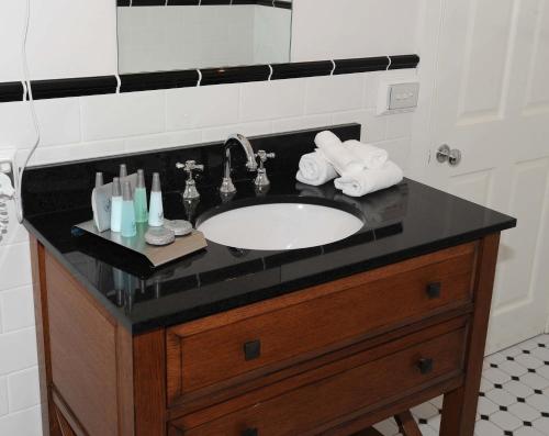 a bathroom sink with a black counter top at The Yarrawonga Hotel in Yarrawonga