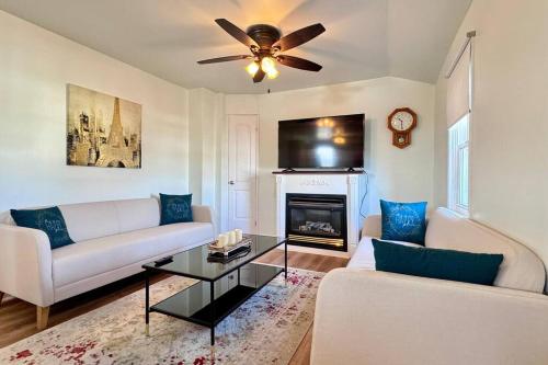 a living room with a couch and a fireplace at Near the Falls Two Bedroom - 5 min Walk to Clifton in Niagara Falls