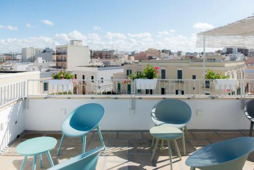 a group of chairs sitting on top of a roof at Monsignore Maisons in Monopoli