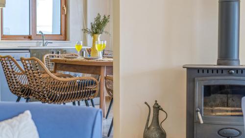 a kitchen with a fireplace and a table with glasses of wine at Villa Panorama, Kalkan, Private Pool, Panoramic Sea View in Kalkan