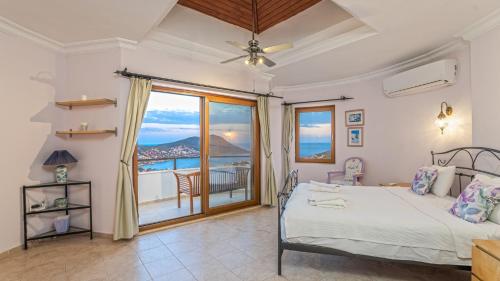 a bedroom with a bed and a view of the ocean at Villa Panorama, Kalkan, Private Pool, Panoramic Sea View in Kalkan