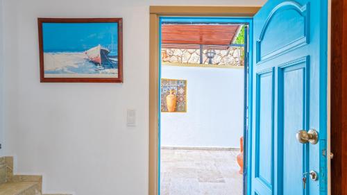 a blue door leading into a room with a window at Villa Panorama, Kalkan, Private Pool, Panoramic Sea View in Kalkan