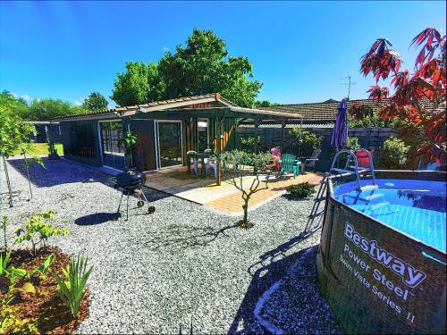 une cour arrière avec une piscine et une maison dans l'établissement MAISON PISCINE PRIVEE 4a5 PERS9 & 11 KMs DES PLAGES OCEANES ET DU LAC, à Linxe