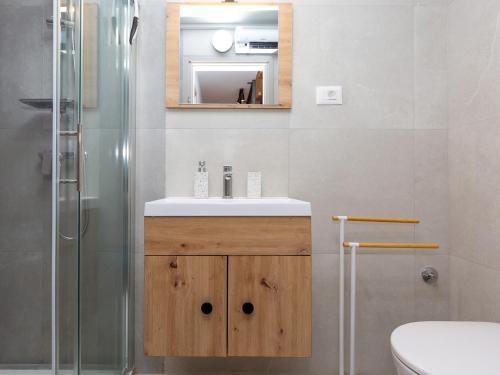a bathroom with a sink and a shower at Casa Novak City Center in Poreč