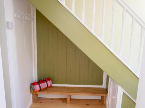 a stairway with a bench under the stairs at St James in Exeter