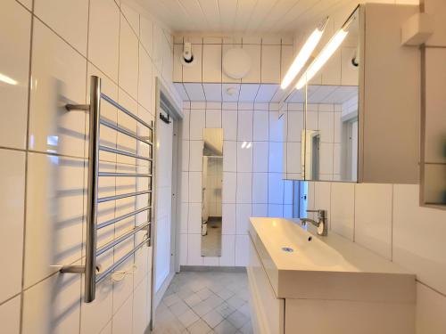 a bathroom with a sink and a mirror at Mercury House, Cathedral View ! Free Parking ! in Trondheim