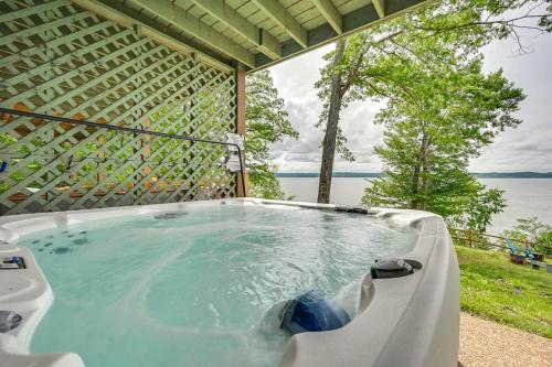 a hot tub with a view of the water at Fox Berry Hill - Lakefront with Dock, Launch & Hot Tub in Waverly