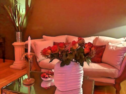 a living room with a vase with flowers on a table at LOFT & SPA PRIVATIF in Dijon