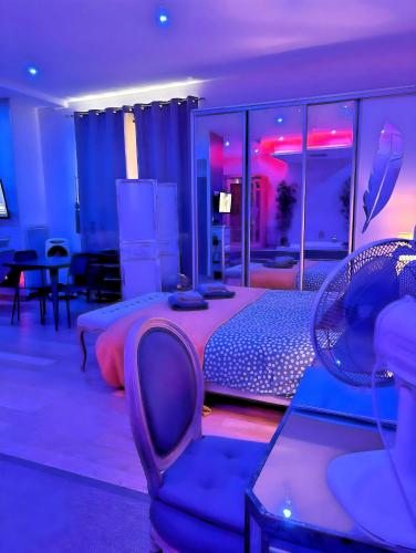 a bedroom with a bed and a chair and a room with at LOFT & SPA PRIVATIF in Dijon
