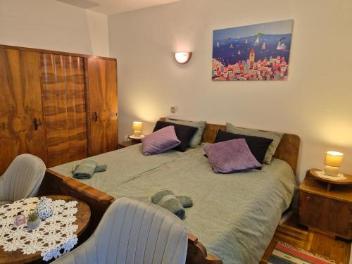 a bedroom with a bed with purple pillows at Lovely 2-bedroom apartment in Novi Vinodolski in Novi Vinodolski