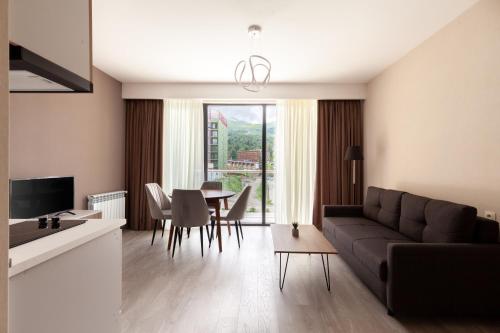 a living room with a couch and a table at Crystal Wood in Bakuriani