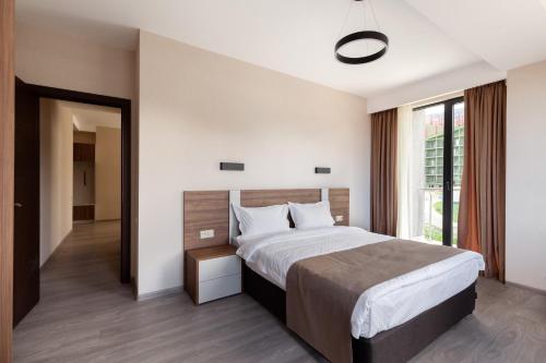 a bedroom with a large bed and a window at Crystal Wood in Bakuriani