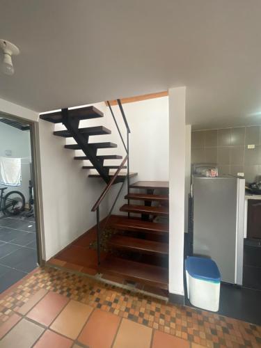 a kitchen with a staircase in a room at Vinculado a las montañas y a la naturaleza in Guasca