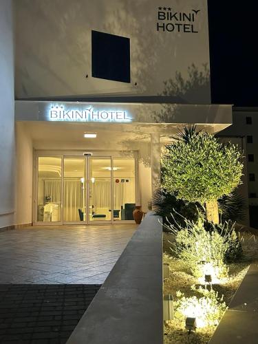 a building with a sign on the front of it at Bikini Hotel in Vieste